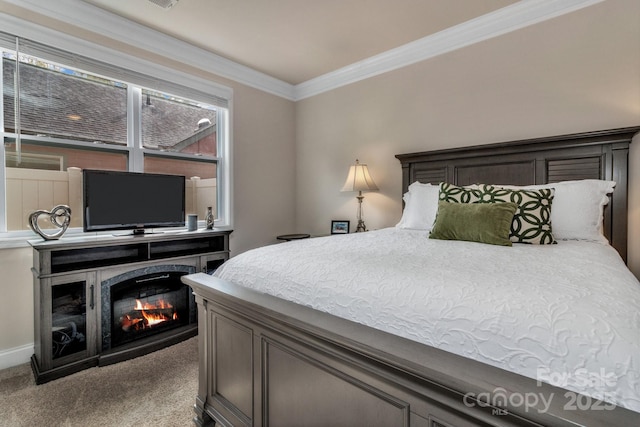 bedroom with crown molding and carpet flooring