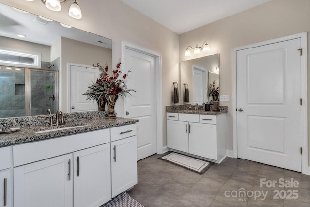 bathroom with vanity and a shower with shower door