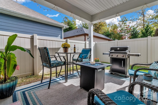 view of patio with a grill and an outdoor fire pit