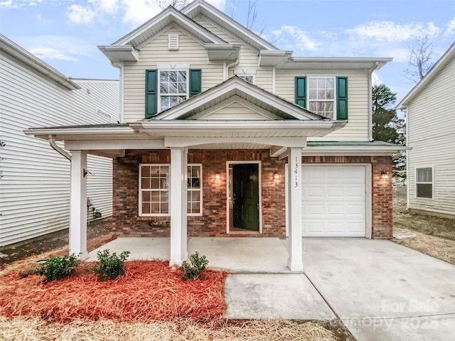 traditional home with an attached garage, driveway, a porch, and brick siding