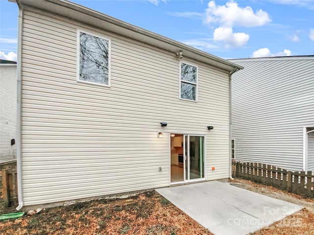 rear view of property with a patio area and fence