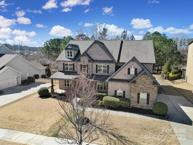 view of front of house with a residential view, concrete driveway, and roof with shingles