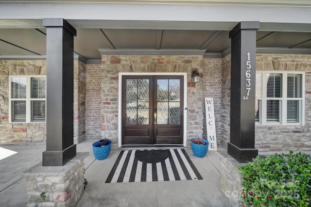 entrance to property with stone siding and french doors