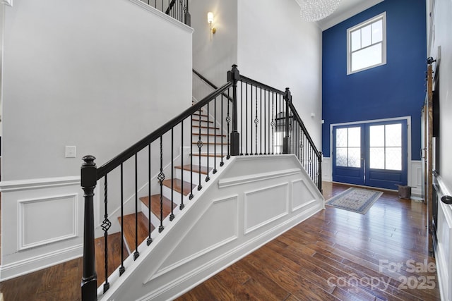 foyer entrance featuring dark wood-type flooring, a wealth of natural light, and french doors