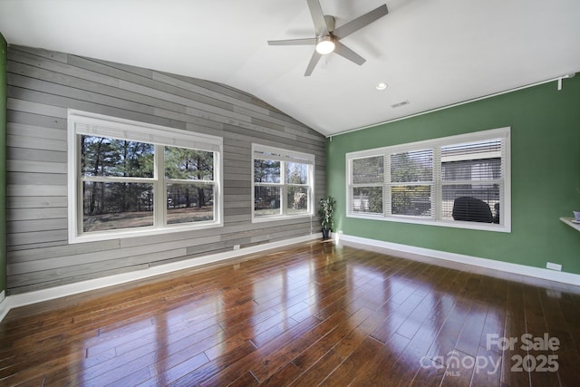 unfurnished room with visible vents, baseboards, a ceiling fan, dark wood-style flooring, and vaulted ceiling