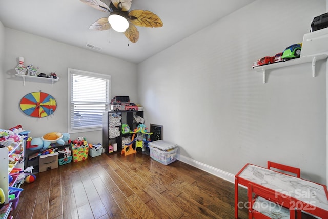 playroom featuring dark wood-style floors, visible vents, baseboards, and a ceiling fan