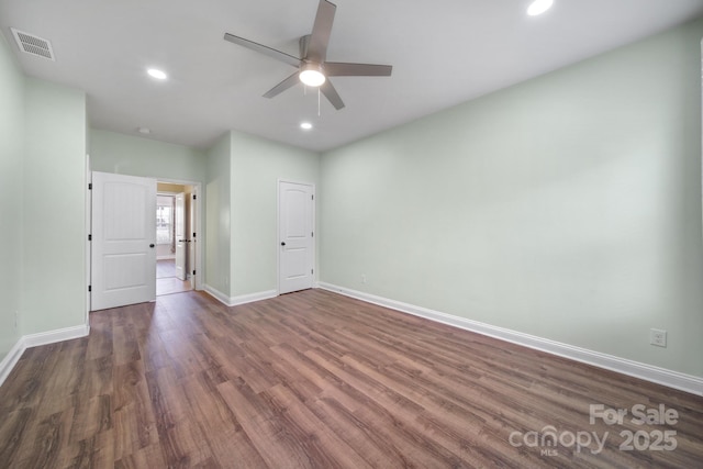 empty room with baseboards, visible vents, ceiling fan, dark wood-style flooring, and recessed lighting