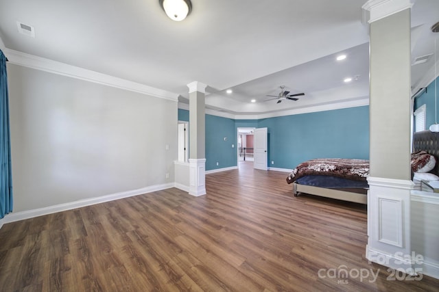 unfurnished bedroom featuring visible vents, dark wood-style floors, decorative columns, and crown molding