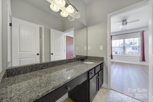 bathroom with ceiling fan, tile patterned floors, vanity, and baseboards