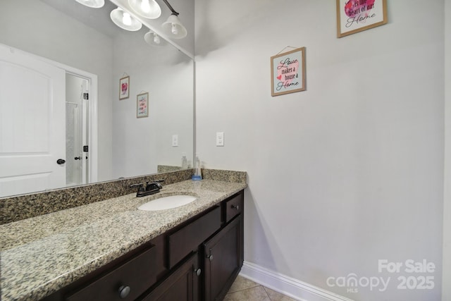 bathroom featuring tile patterned flooring, vanity, and baseboards