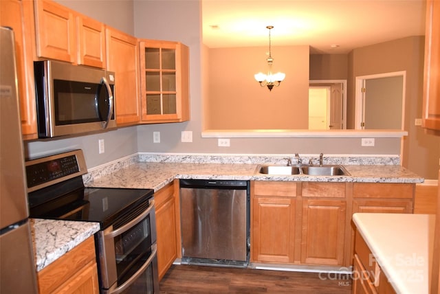 kitchen featuring decorative light fixtures, a notable chandelier, appliances with stainless steel finishes, glass insert cabinets, and a sink