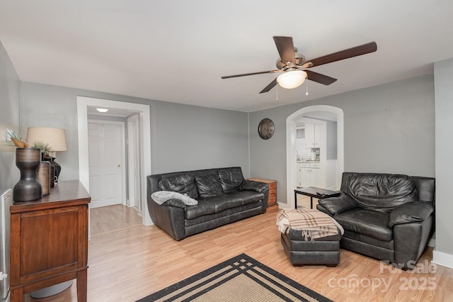 living room with ceiling fan and hardwood / wood-style floors