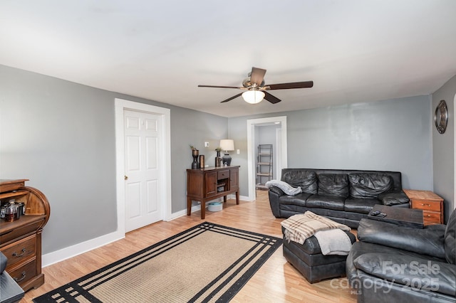 living room with ceiling fan and light hardwood / wood-style flooring