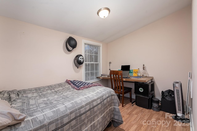 bedroom featuring vaulted ceiling and light wood-type flooring