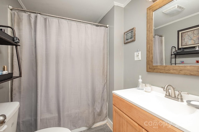 bathroom featuring vanity, ornamental molding, toilet, and walk in shower