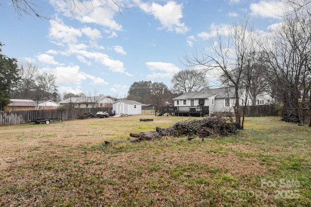 view of yard featuring a wooden deck and a shed