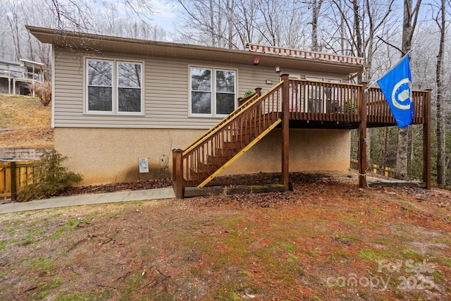 rear view of house featuring a deck