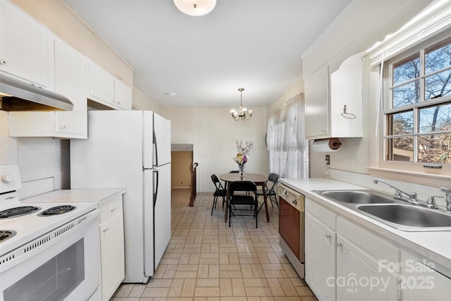 kitchen featuring white cabinetry, white appliances, decorative light fixtures, and sink