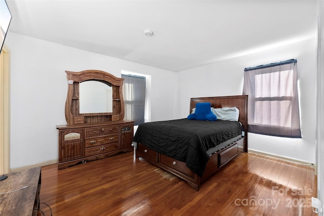 bedroom with dark hardwood / wood-style floors