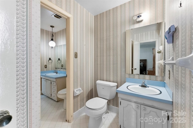 bathroom with tile patterned floors, toilet, and vanity