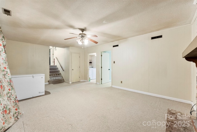 interior space featuring ceiling fan and a textured ceiling