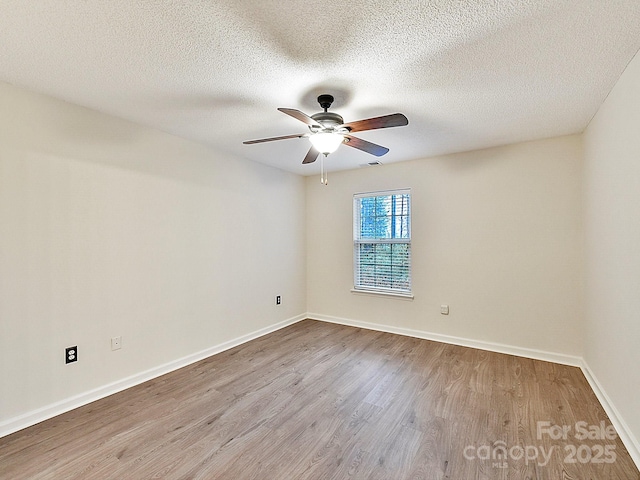 unfurnished room featuring a ceiling fan, a textured ceiling, baseboards, and wood finished floors