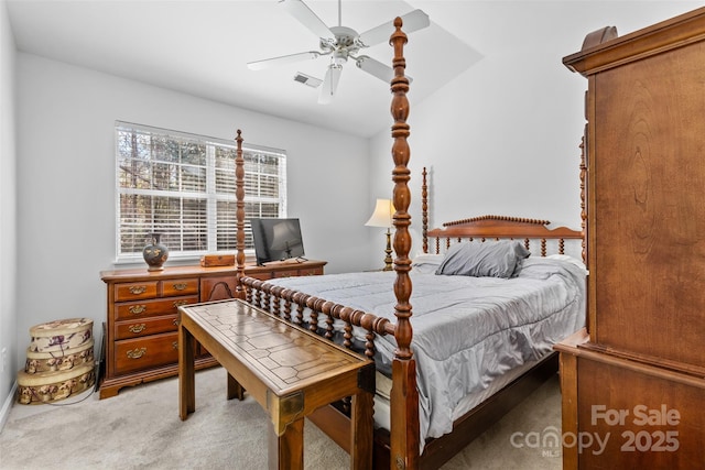 bedroom featuring lofted ceiling, light colored carpet, and visible vents