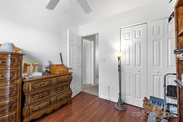 bedroom with a ceiling fan, wood finished floors, a closet, and baseboards