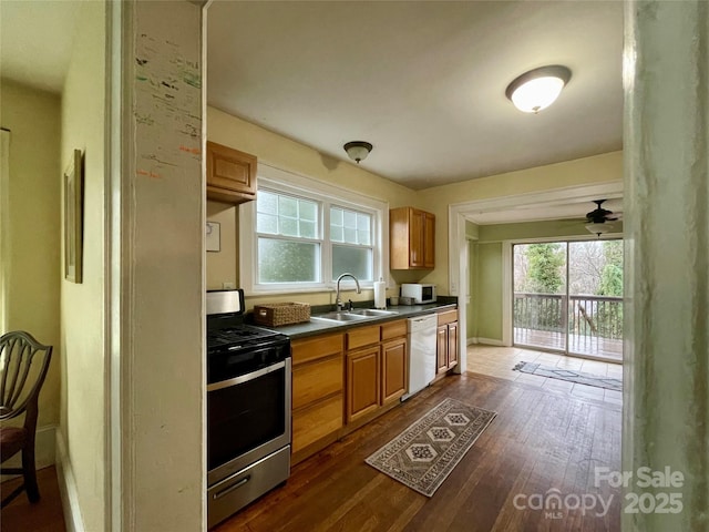 kitchen featuring white appliances, dark hardwood / wood-style floors, and sink