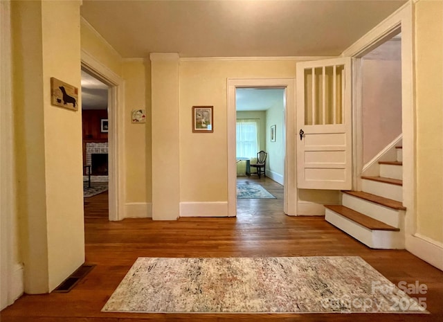 corridor with hardwood / wood-style floors