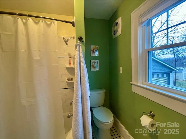 bathroom featuring toilet and walk in shower