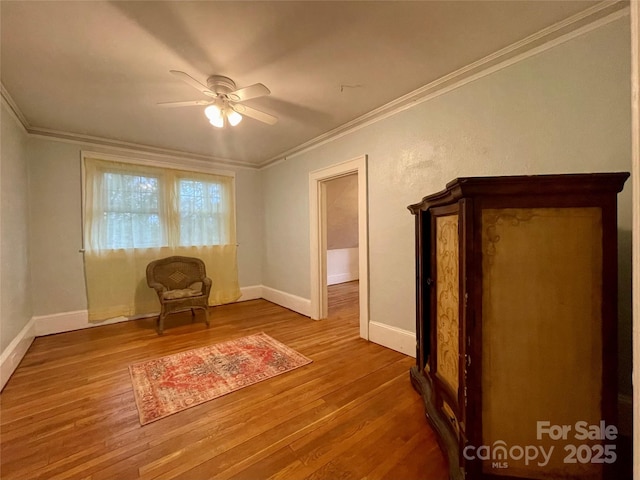 unfurnished room featuring hardwood / wood-style flooring, ornamental molding, and ceiling fan