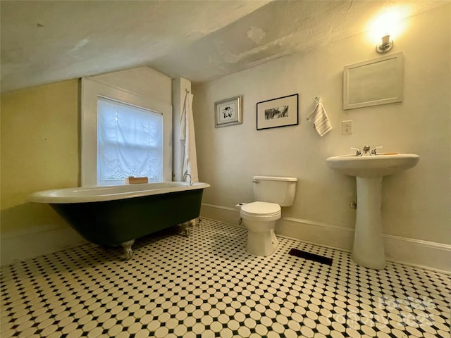 bathroom with vaulted ceiling and toilet