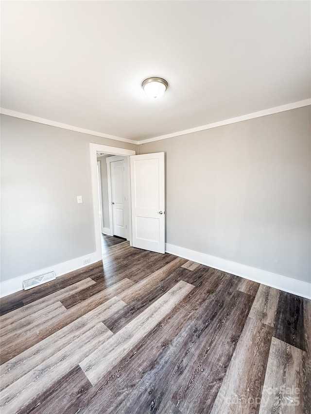 unfurnished room featuring ornamental molding and hardwood / wood-style floors