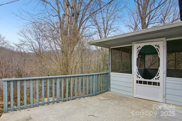 view of patio / terrace featuring a sunroom