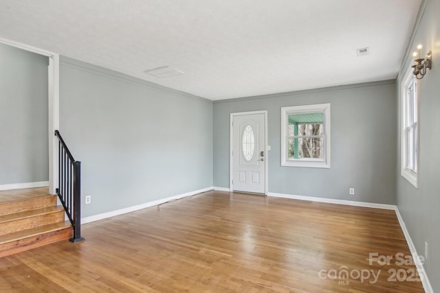 entryway featuring visible vents, stairway, baseboards, and wood finished floors