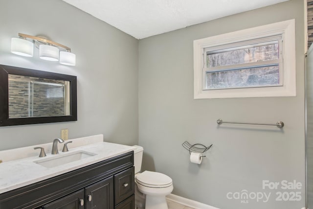 bathroom with a shower with shower door, baseboards, toilet, and vanity