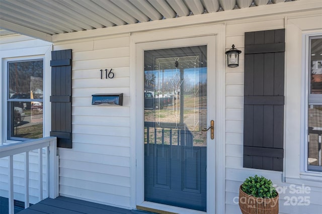 view of exterior entry with a porch