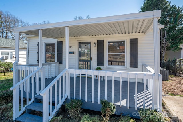 view of front of property with covered porch and central air condition unit