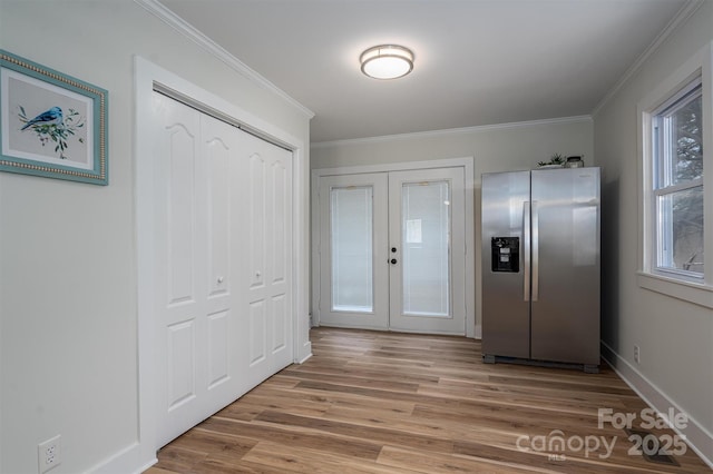 interior space with crown molding, wood finished floors, and stainless steel fridge with ice dispenser