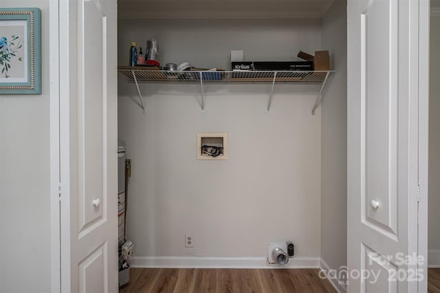 laundry area with hookup for a washing machine, laundry area, baseboards, and wood finished floors