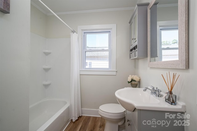 bathroom featuring toilet, ornamental molding, wood finished floors, and vanity