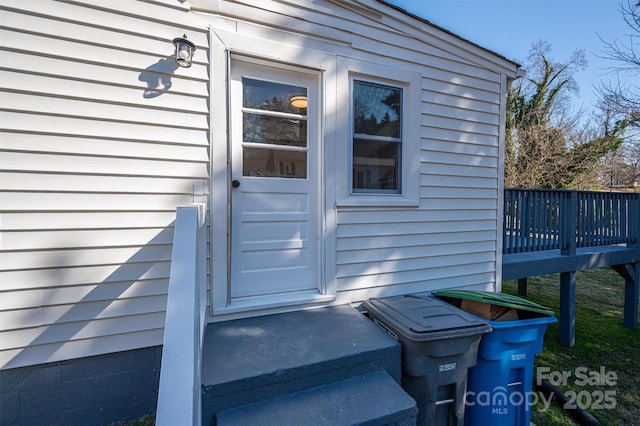 entrance to property featuring a wooden deck