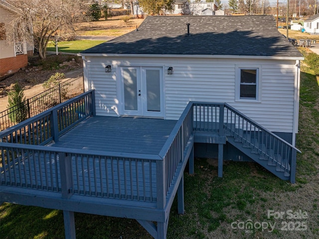 rear view of house featuring a shingled roof, stairs, and a wooden deck