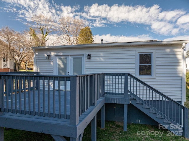 back of property with stairway and a wooden deck