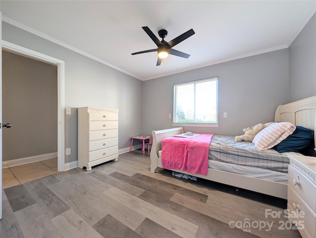 bedroom with ornamental molding, ceiling fan, and light wood-type flooring