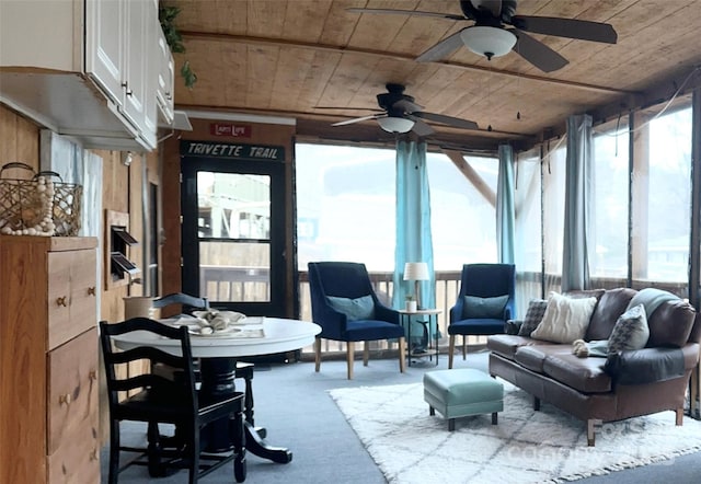 sunroom with ceiling fan, wood ceiling, and a healthy amount of sunlight