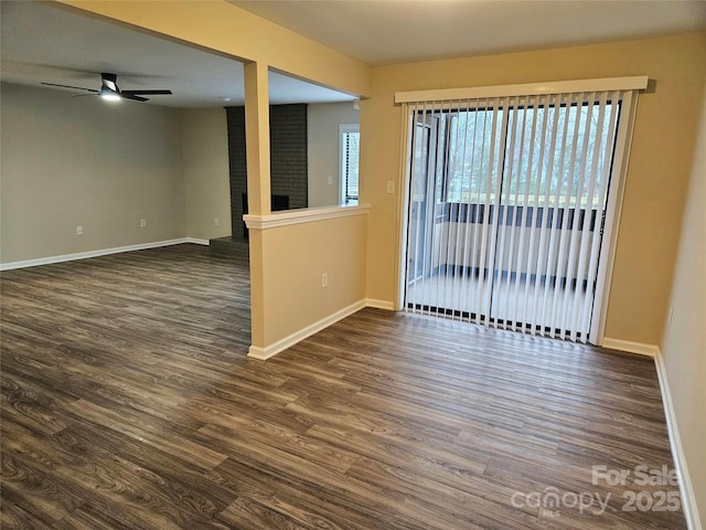 spare room with dark hardwood / wood-style flooring and ceiling fan