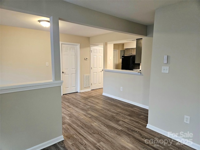 unfurnished room featuring dark hardwood / wood-style flooring