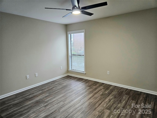 empty room with dark hardwood / wood-style floors and ceiling fan